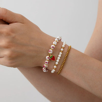 Mystiquè Gold-Plated Floral Beaded Bracelet with Pearl & Strawberry Charm